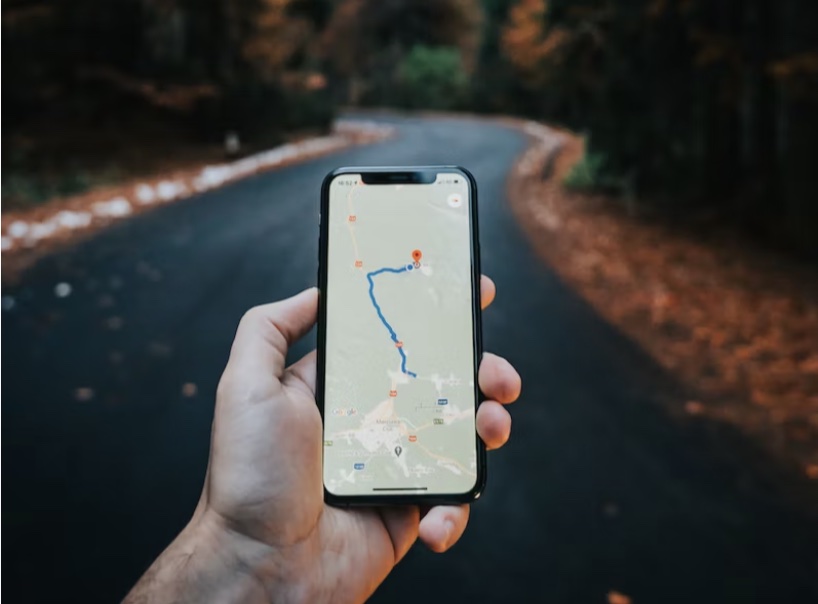 a hand looking at directions on a mobile device
