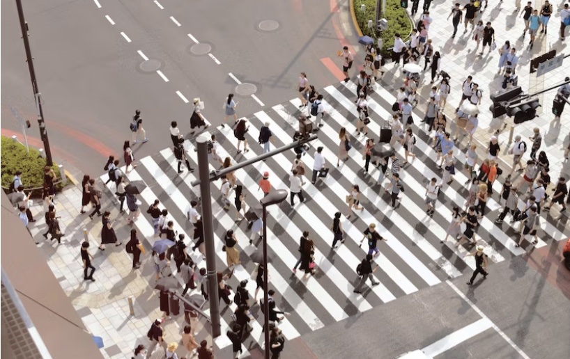 a crowd walking in a cross walk