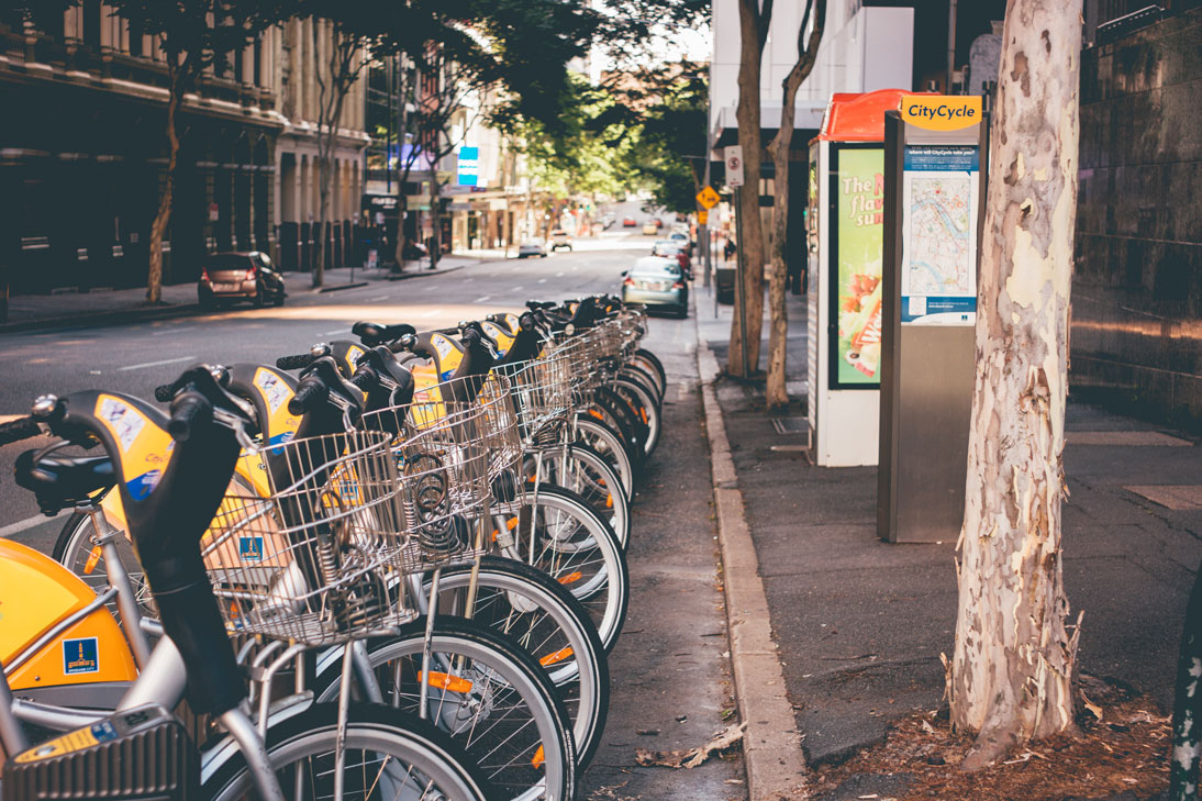 a street with bicycles and digital signage